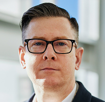 Alexander Hughes, dyrektor generalny spółki działającej w obszarze handlu kryptowalutami, portret